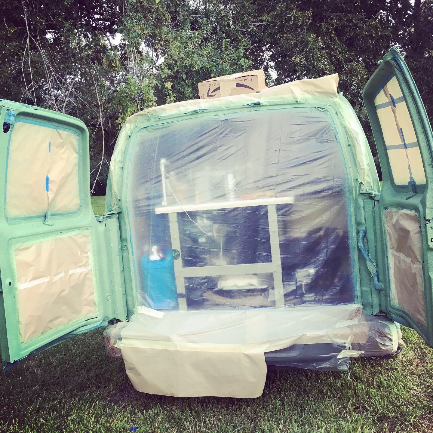 Last day of a DIY bed liner paint job on my Chevy express van turned into a camper and tiny workshop on wheels.